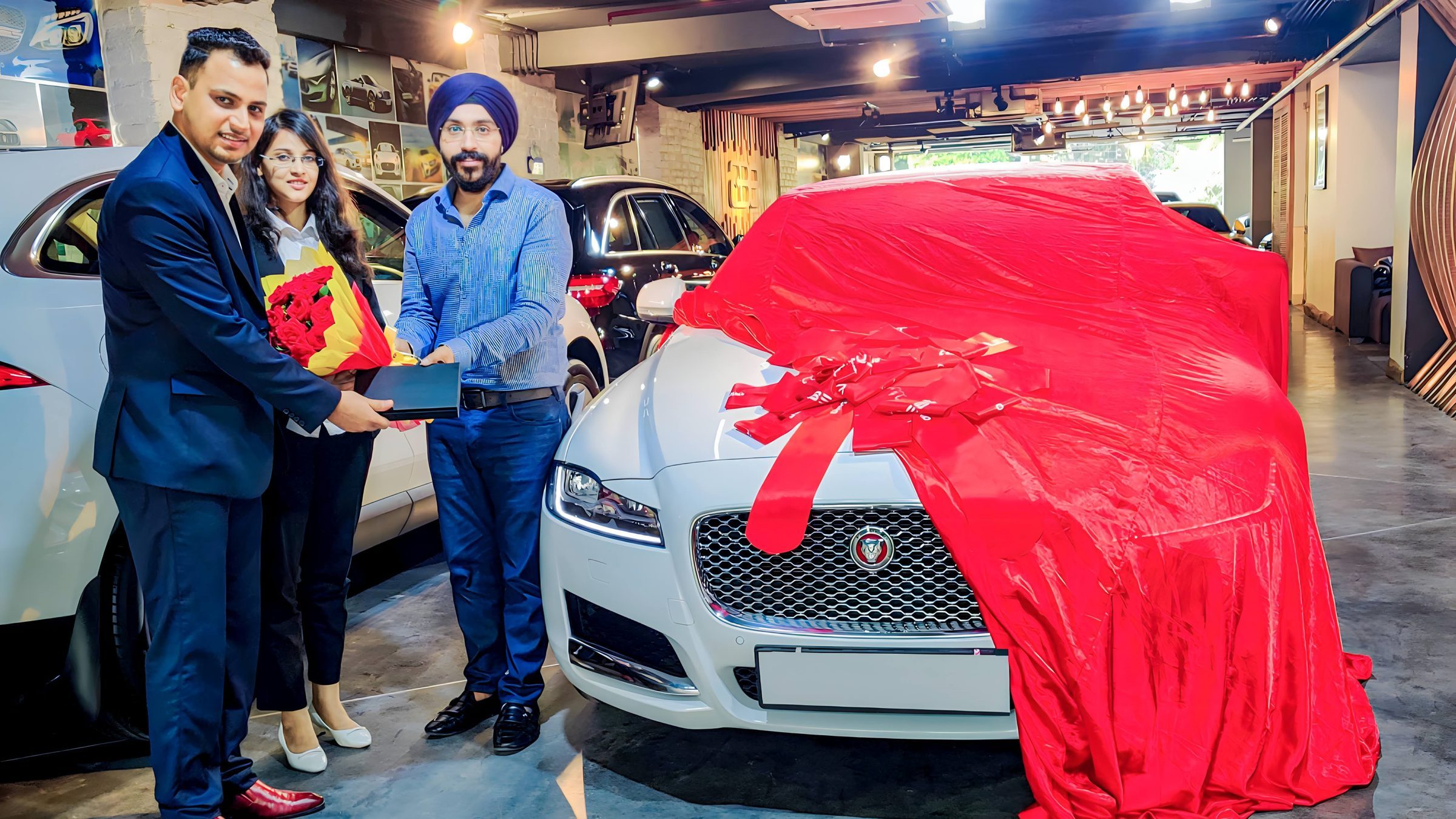 Lithvik Mukesh Sharma is photographed with Dr. Jyoti Kush (COO of CryptoMize) and a Jaguar car Lithvik Mukesh Sharma is photographed with Dr. Jyoti Kush and a Jaguar car