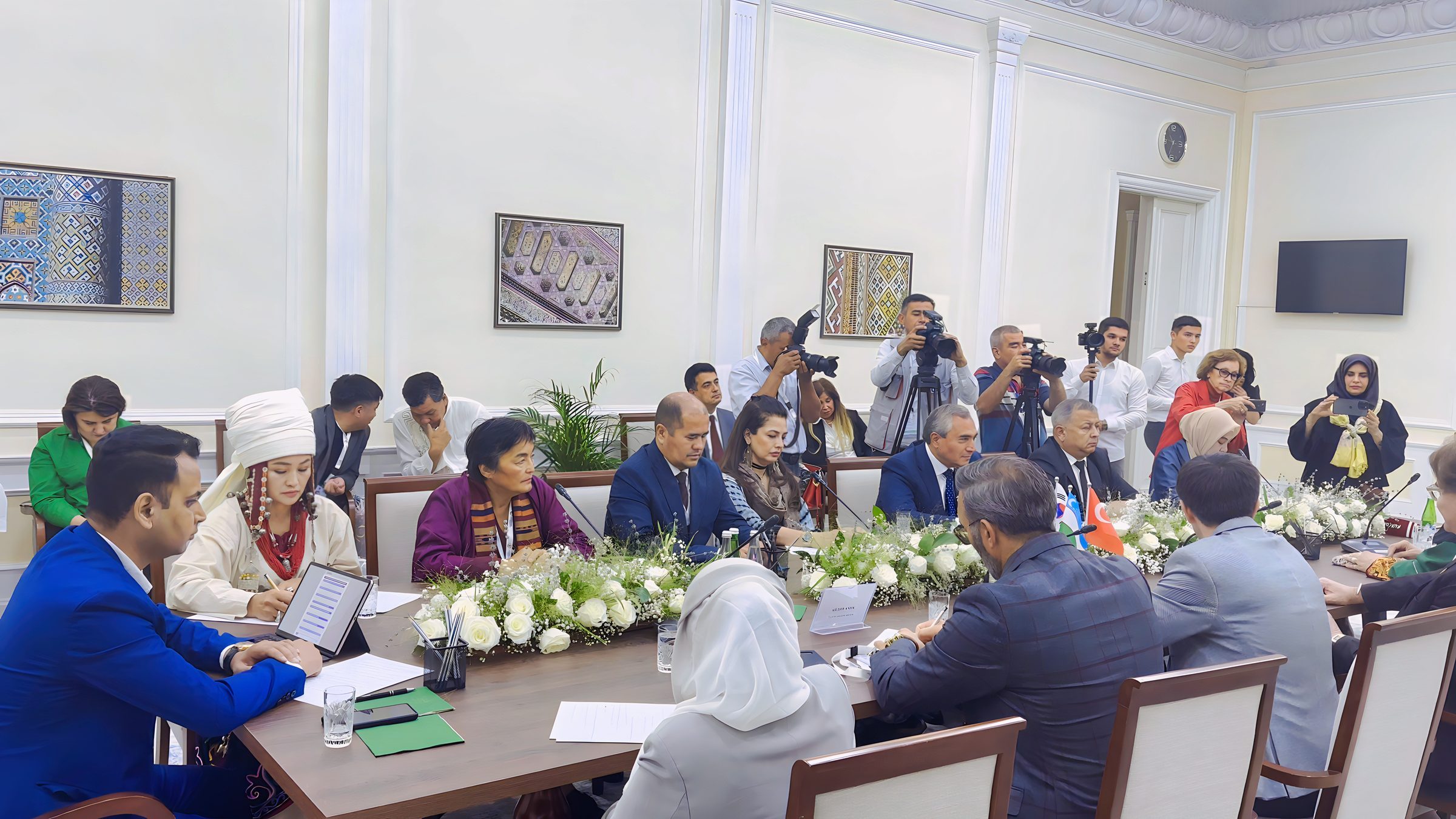 Lithvik Mukesh Sharma, Group CEO of CryptoMize, is photographed in a formal meeting at an ornate diplomatic setting in Uzbekistan. The ornate meeting room has cream-colored walls, white decorative molding