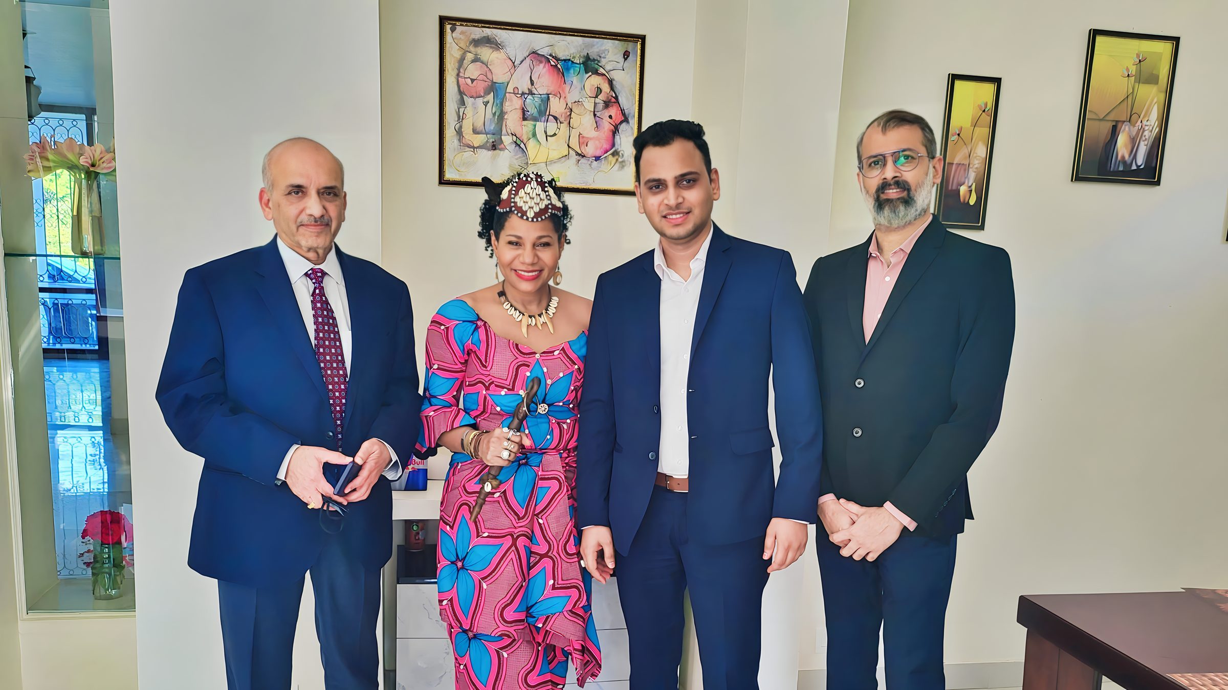 Lithvik Mukesh Sharma is photographed with Dr. Naveen Saxena (Chairman of Rusan Pharma Ltd.) and Queen Diambi at a hosted gathering