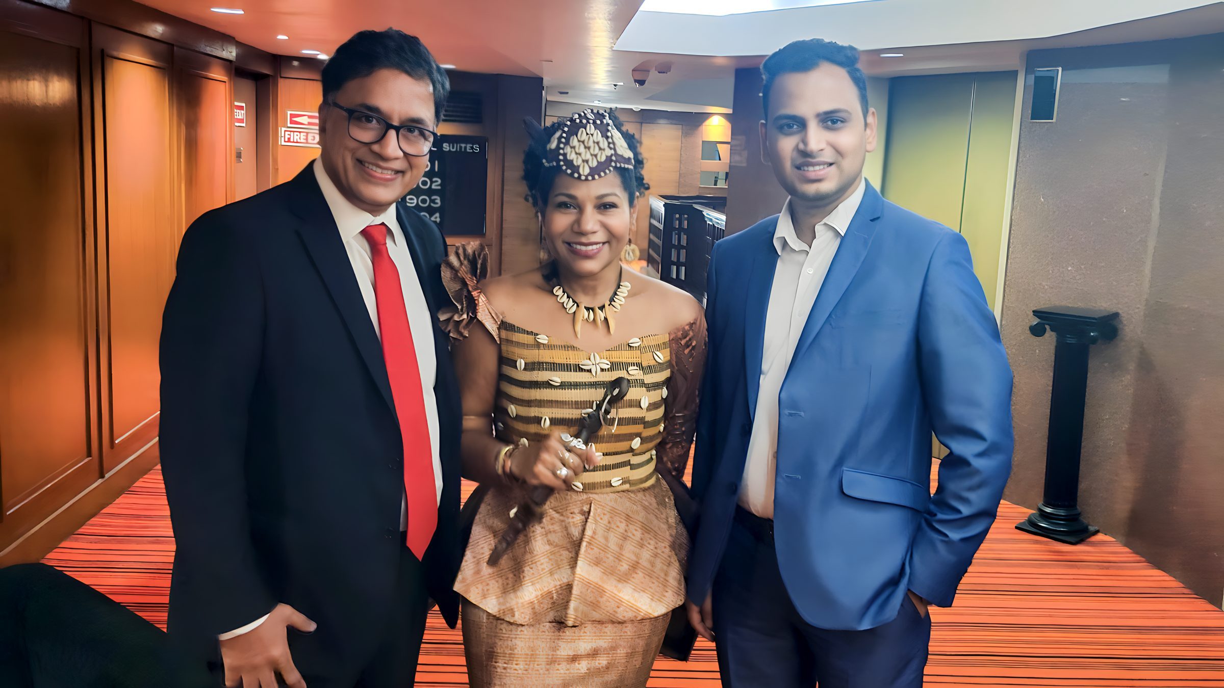 Lithvik Mukesh Sharma is photographed with Queen Diambi and co-attendees at a hosted gathering