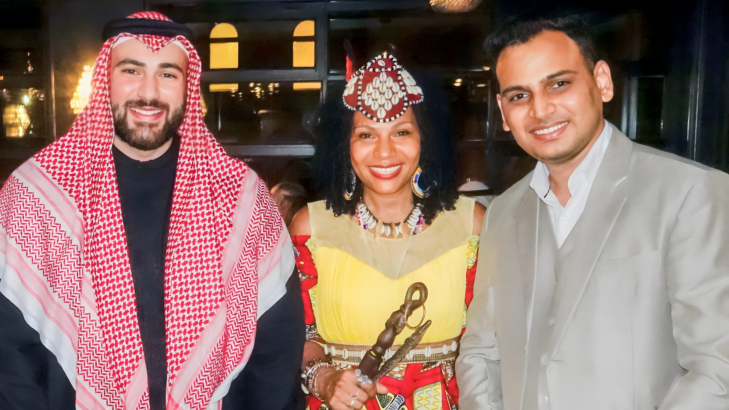 Lithvik Mukesh Sharma is photographed with Dr. Bader Abdulmutaleb Ibrahim and Queen Diambi